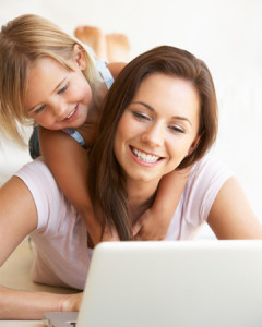 mom-working-from-home-with-happy-daughter-vert