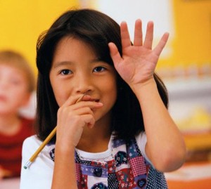 Cropped student raising hand
