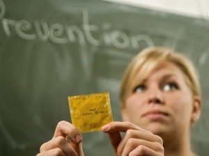 Sex education - teen classroom with condom